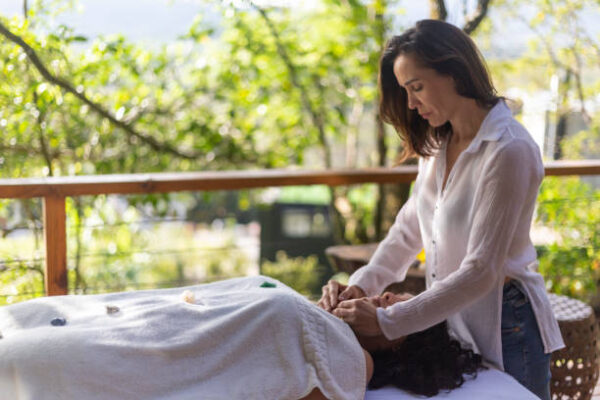 A Reiki practitioner gently channeling energy during a calming Reiki healing session for a beginner.