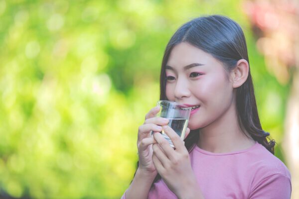 beautiful woman drink clean water from glass water