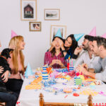 A joyful group of friends celebrating a birthday at home, showcasing the essence of affordable event planning.