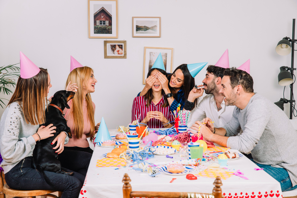 A joyful group of friends celebrating a birthday at home, showcasing the essence of affordable event planning.